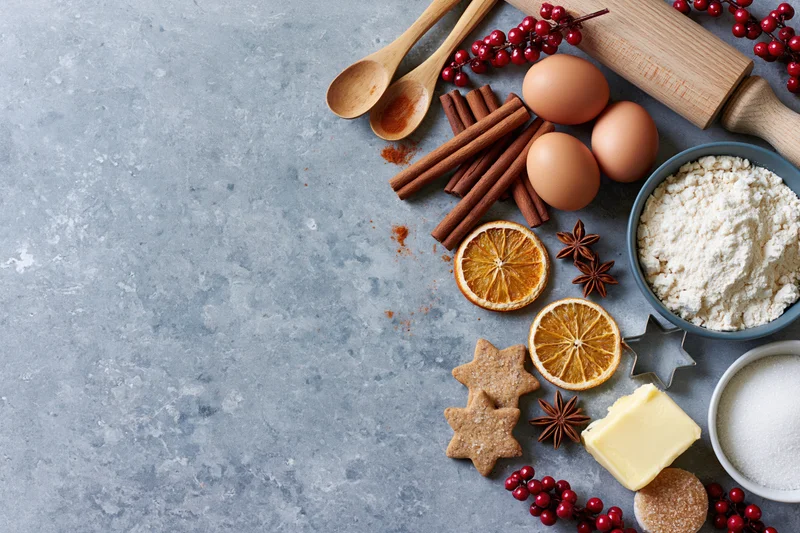Baking ingredients arranged on a gray countertop with copyspace for holiday recipe presentation