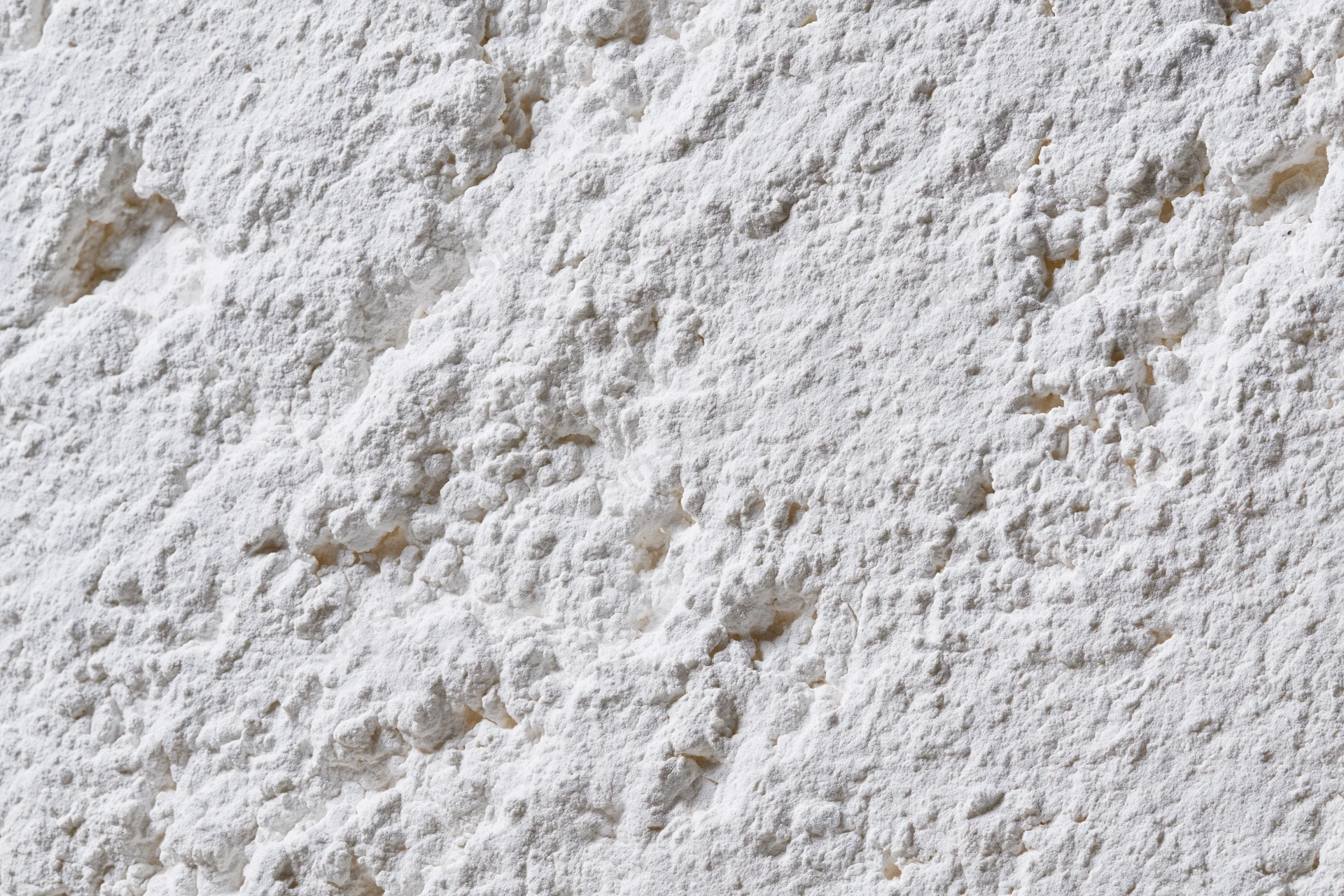 Closeup of white powder texture with clumps and fine granules