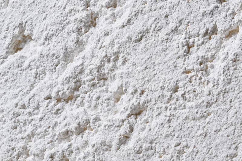 Closeup of white powder texture with clumps and fine granules