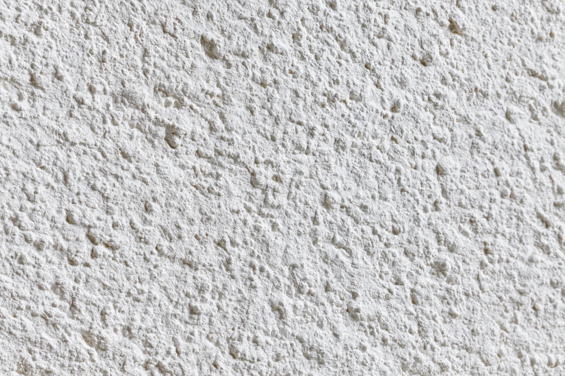 Close-up of textured white plaster wall surface