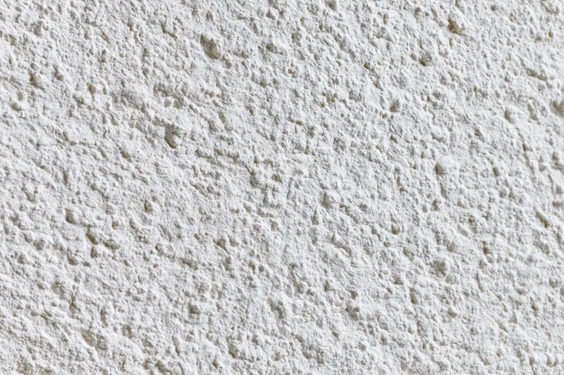 Close-up of textured white plaster wall surface