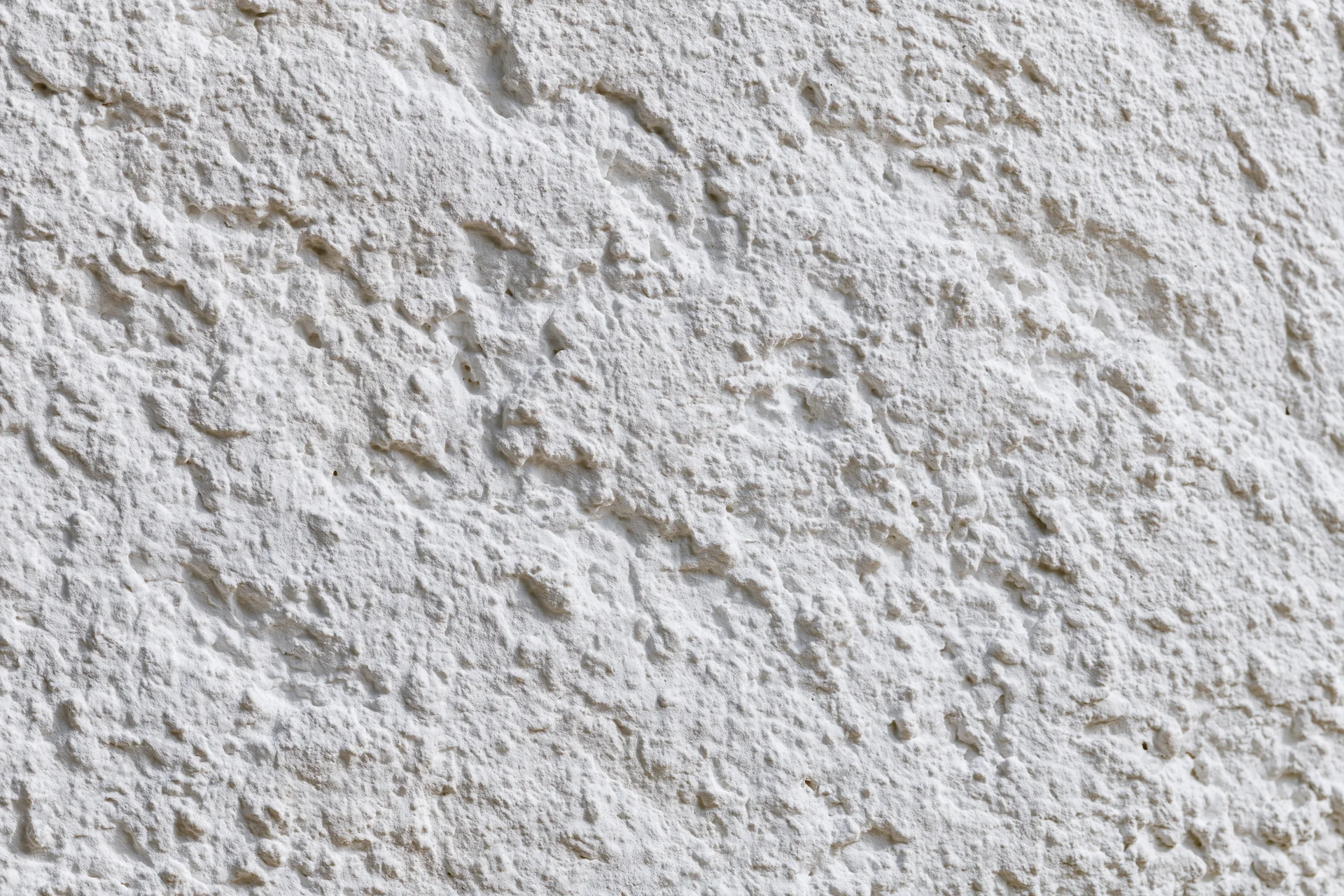 Close-up of textured white plaster wall surface