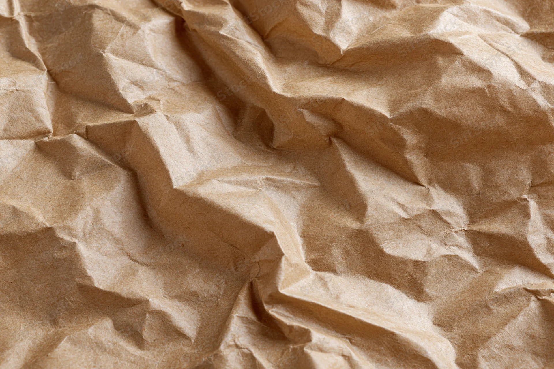 Crumpled brown paper texture filling the frame as a natural material background