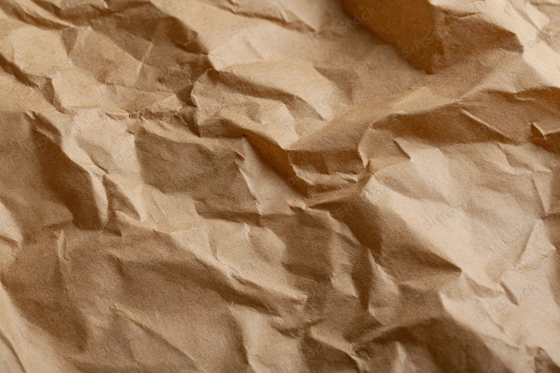 Crumpled brown paper texture filling the frame