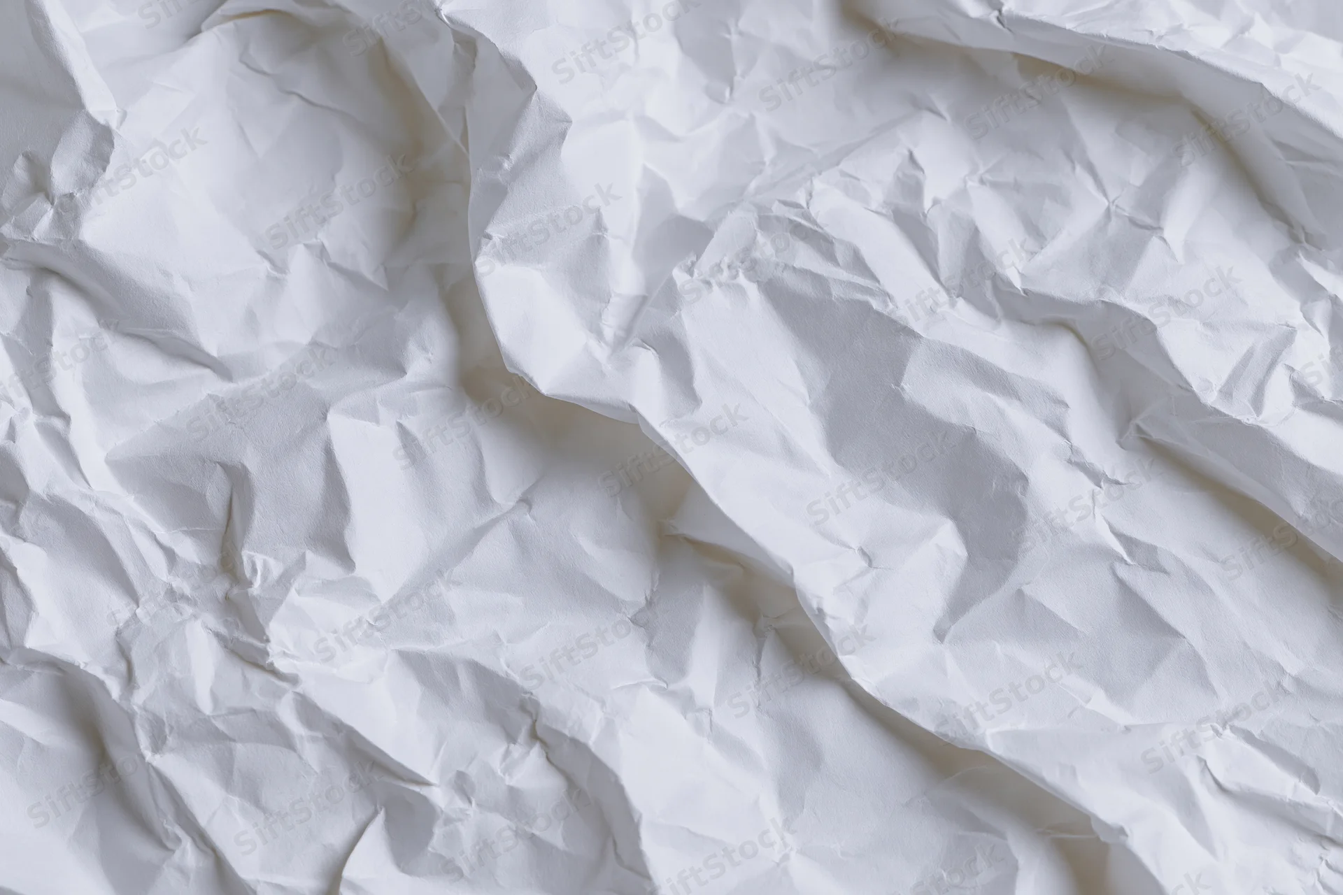 Crumpled white paper texture filling the frame as a background