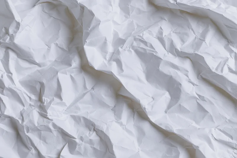 Crumpled white paper texture filling the frame as a background