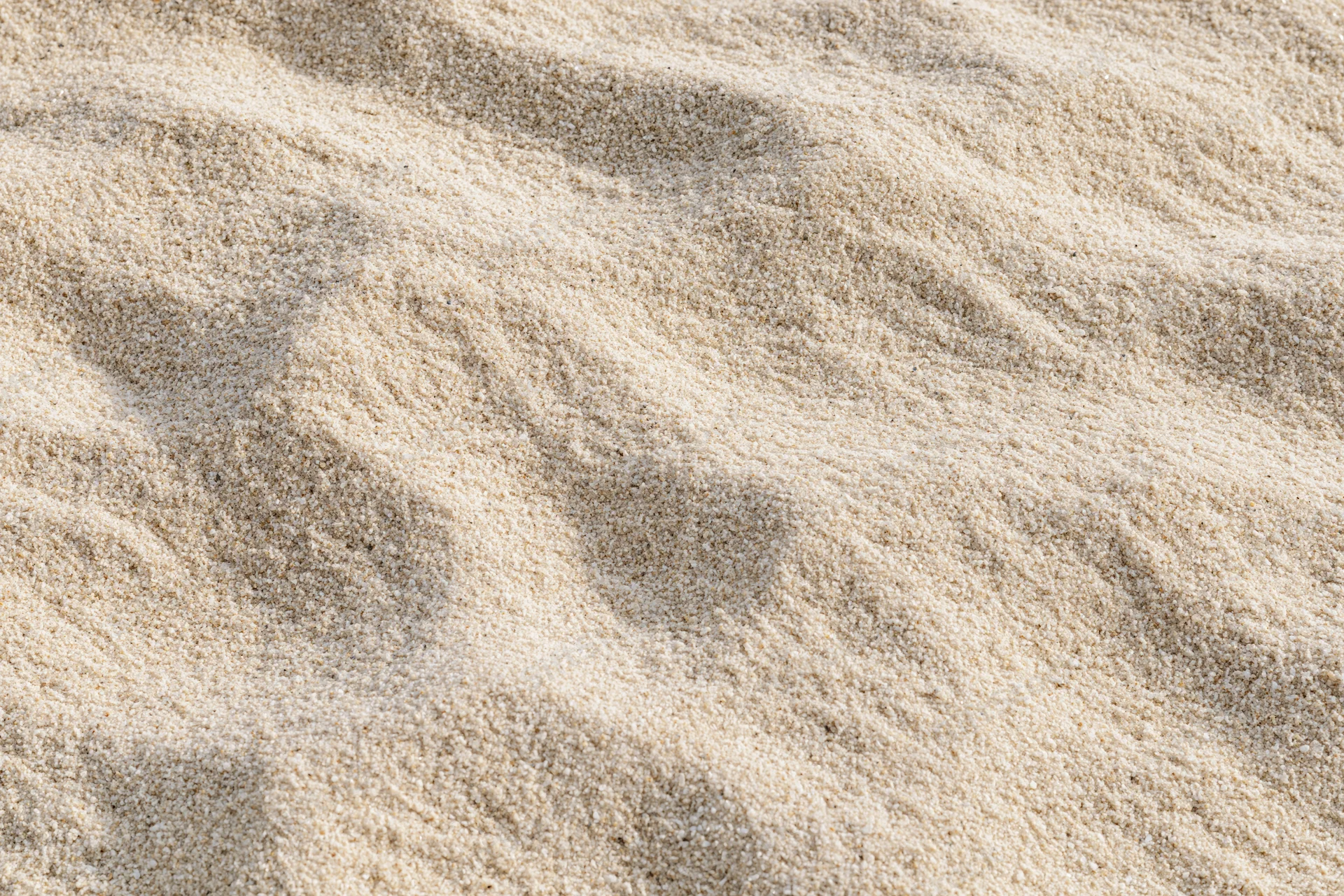 Closeup of rippled sand surface under sunlight on a beach