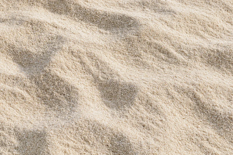 Closeup of rippled sand surface under sunlight on a beach