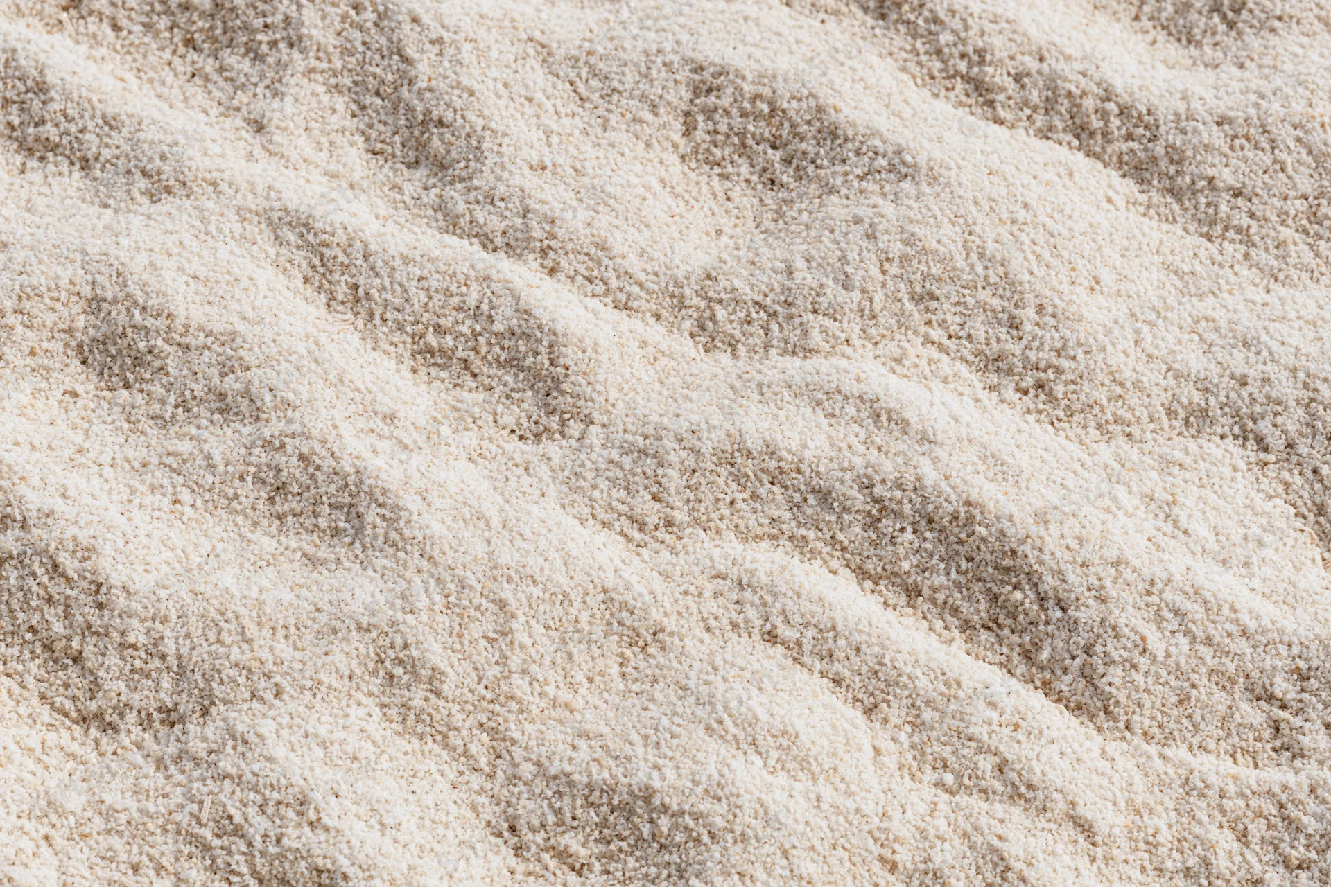 Close-up of beige carpet texture with wavy pile pattern filling the frame