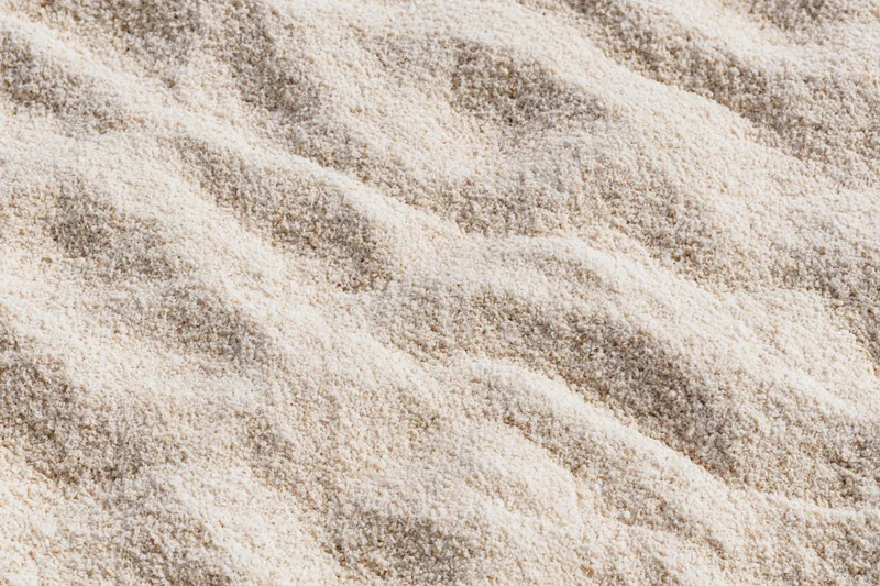 Close-up of beige carpet texture with wavy pile pattern filling the frame