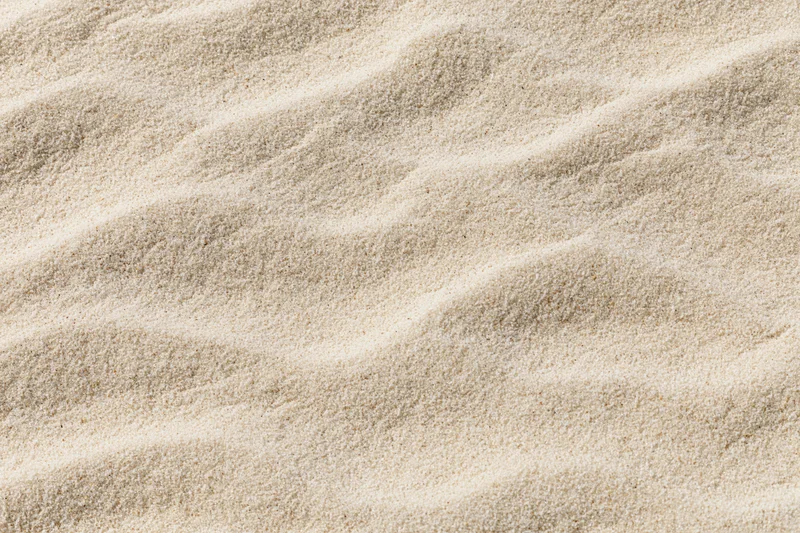 Closeup of rippled sand surface with natural texture and soft lighting