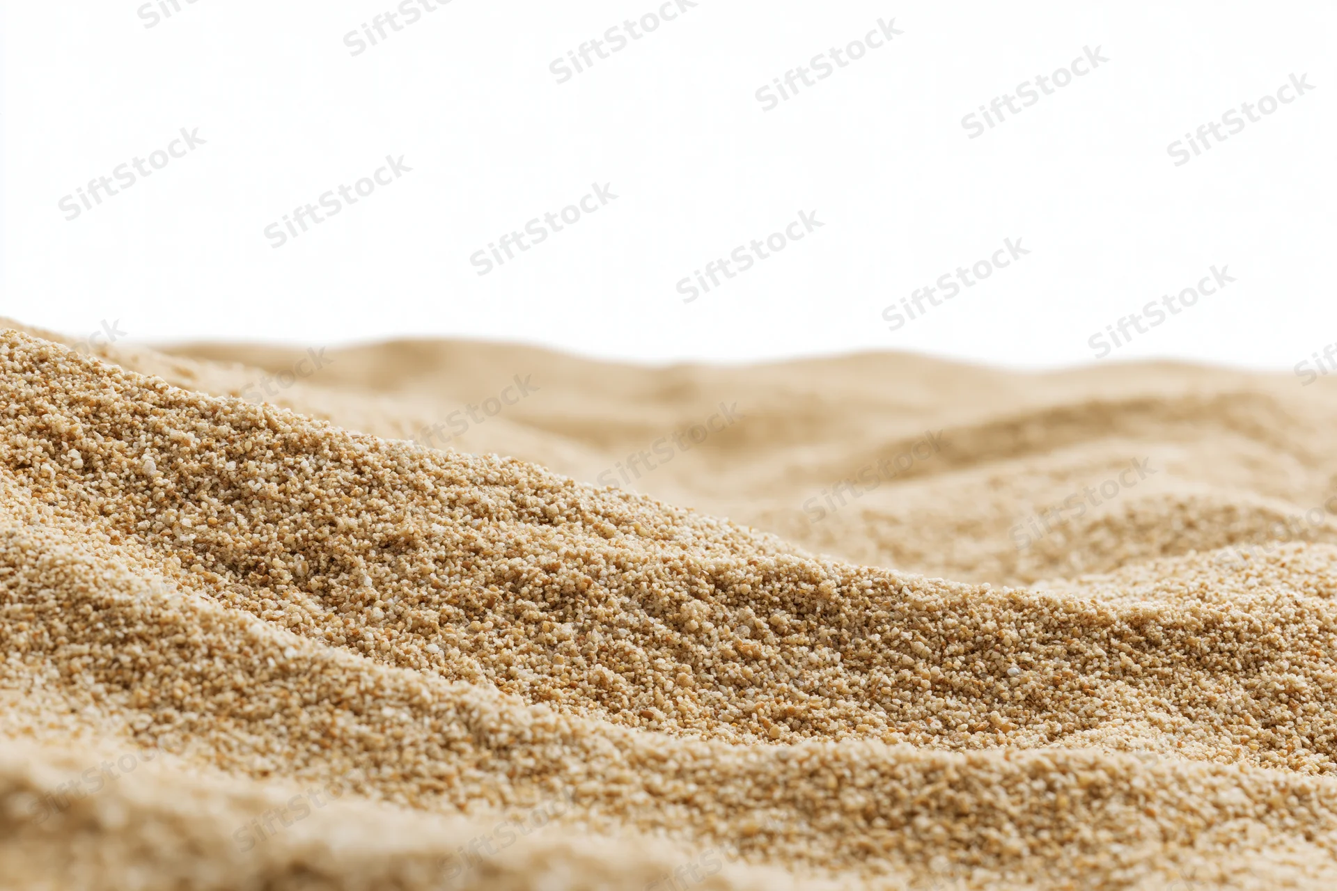 Closeup of quinoa grains piled in a mound on a white background