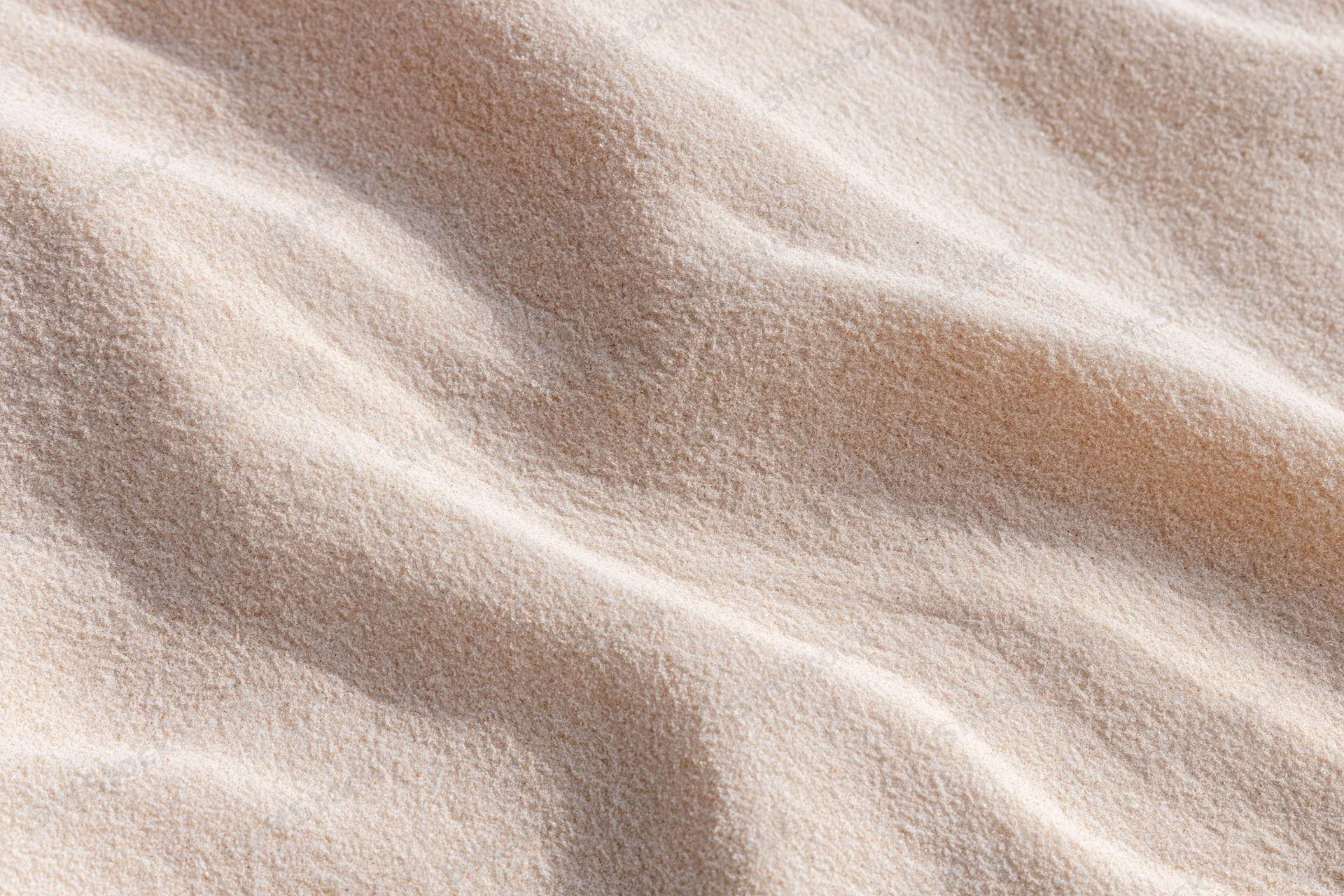Rippled sand surface in a desert landscape under sunlight