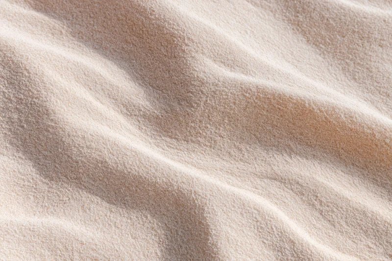 Rippled sand surface in a desert landscape under sunlight