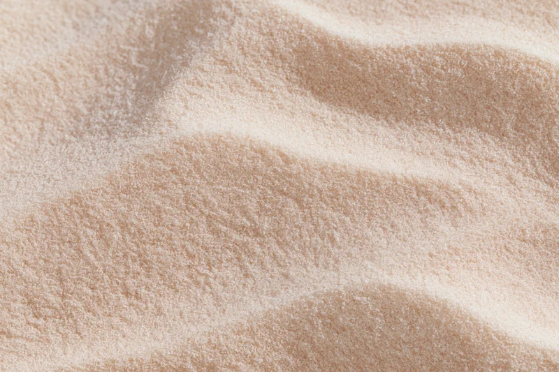 Closeup of beige plush fabric with soft texture and gentle folds