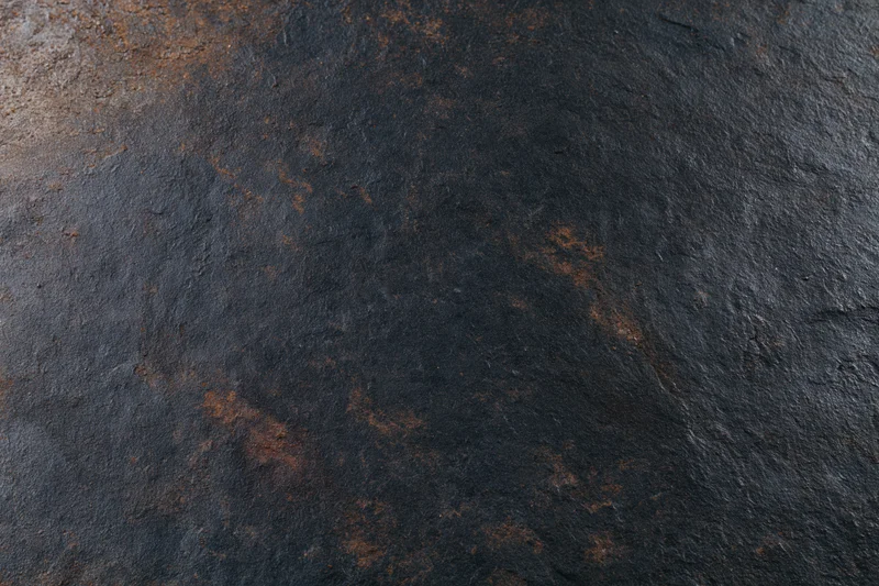 Closeup of rusted metal surface with dark weathered texture