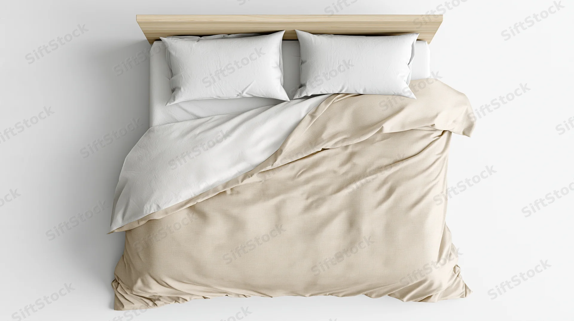 Overhead view of unmade bed with white and beige bedding against white wall
