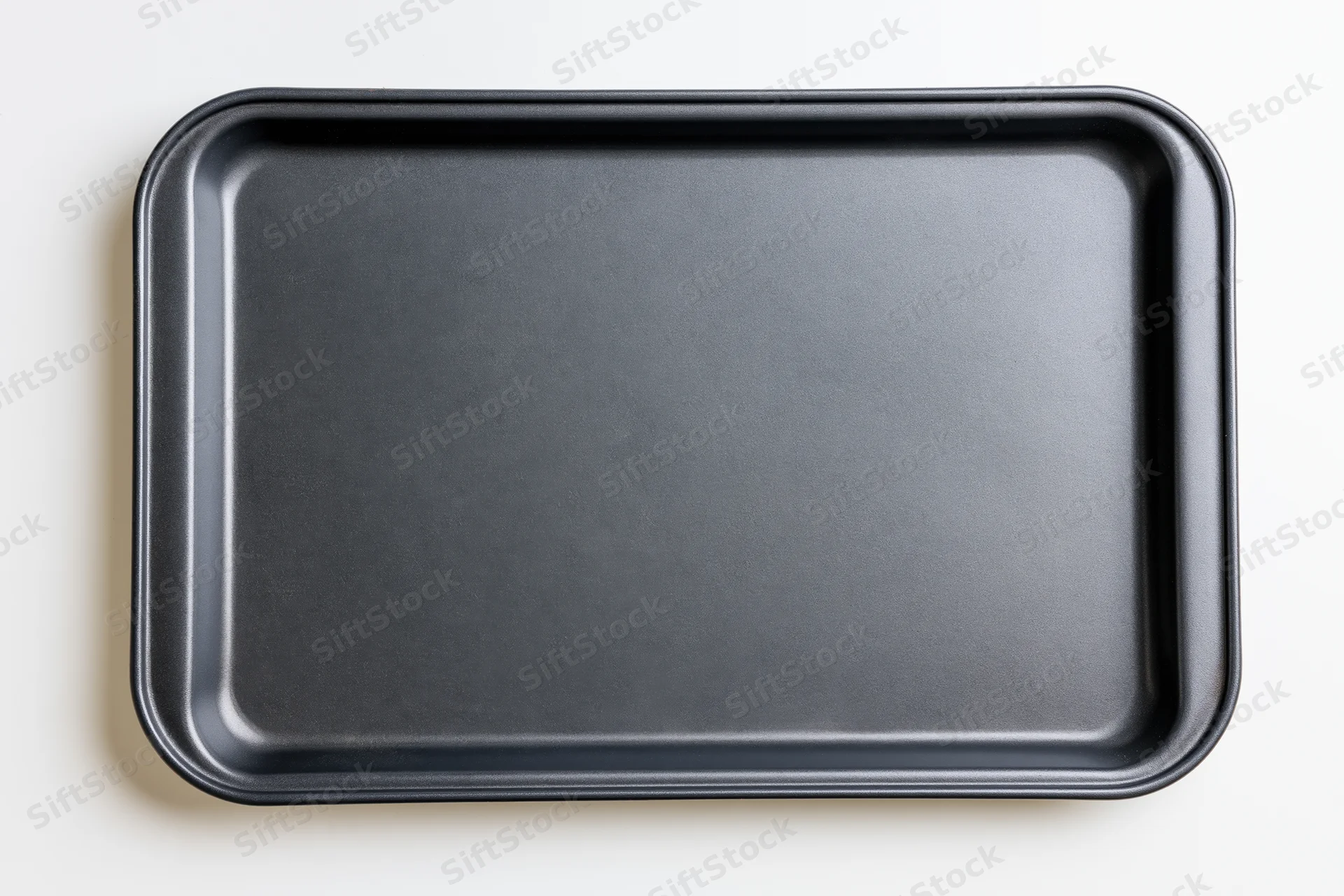 Black nonstick baking tray viewed from above on white background