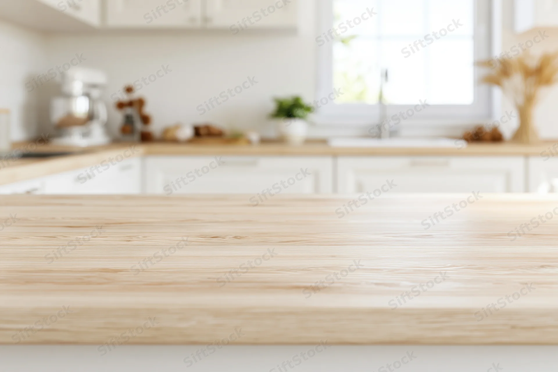 Wooden kitchen countertop in a bright modern home interior with white cabinetry and window in background