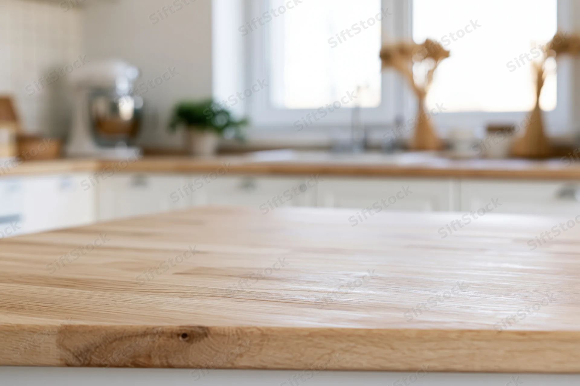 Wooden cutting board resting on kitchen countertop with blurred background