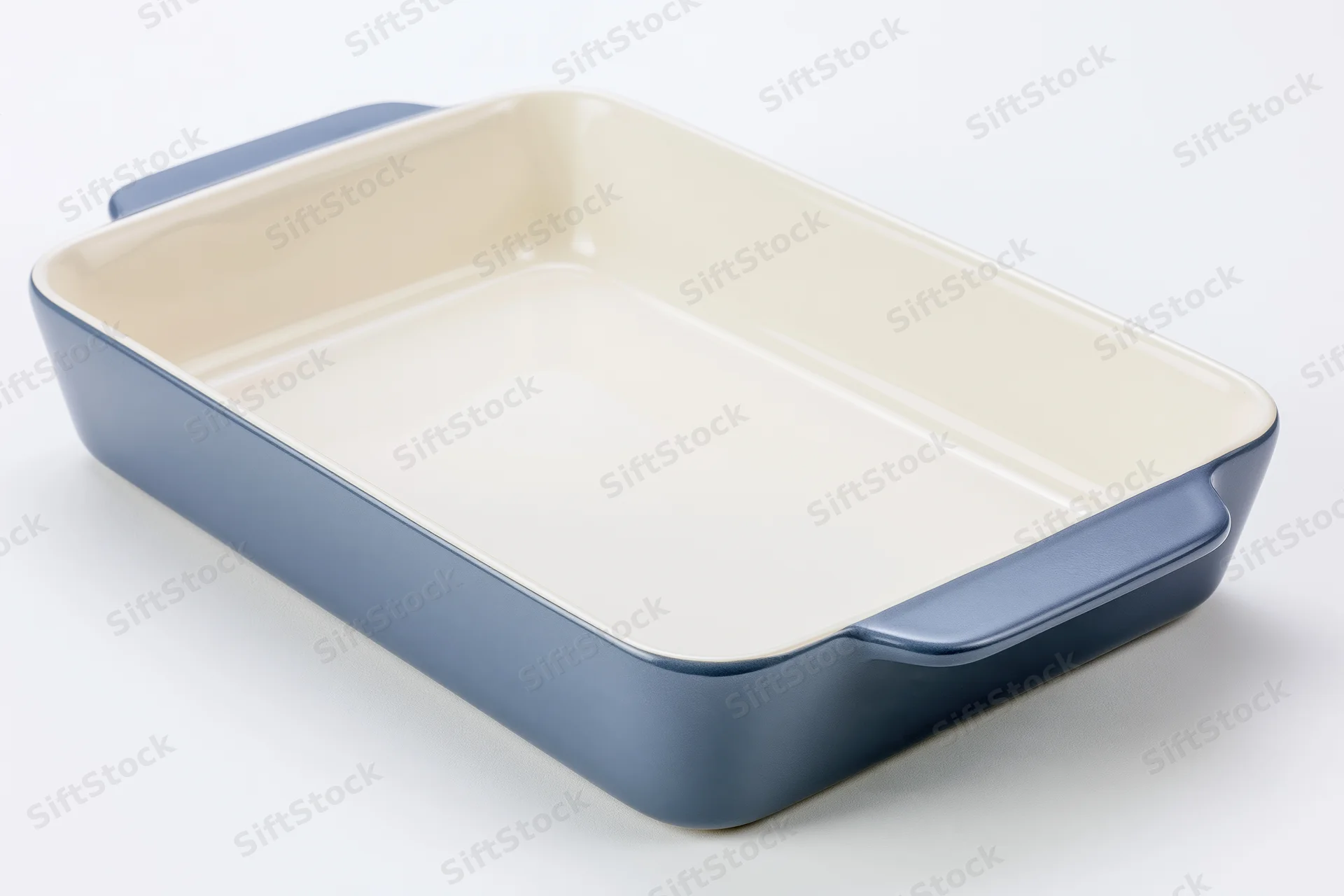 Blue ceramic baking dish with cream interior on white background