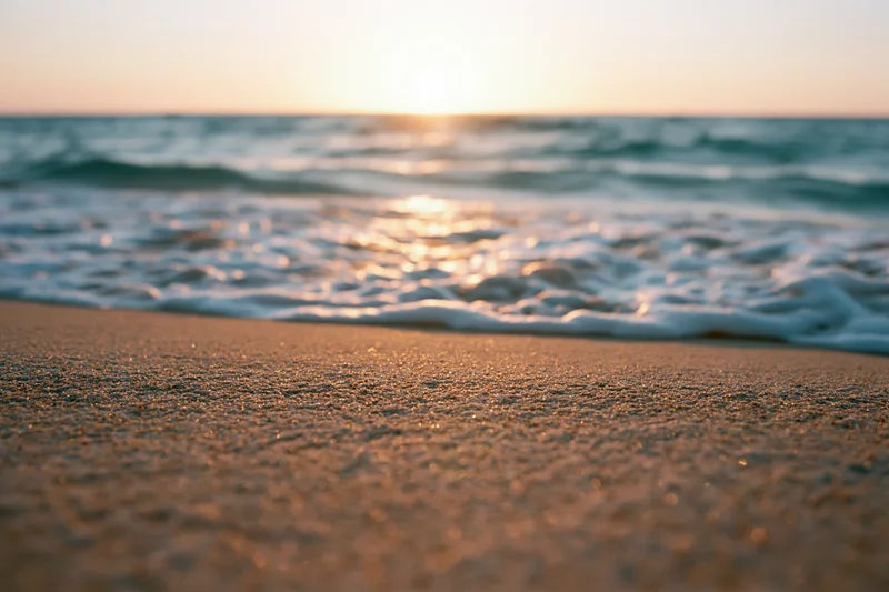 Waves washing over sand at sunset on a beach