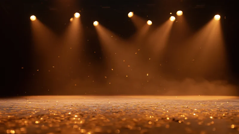 Stage floor illuminated by spotlights with floating dust particles in warm golden light