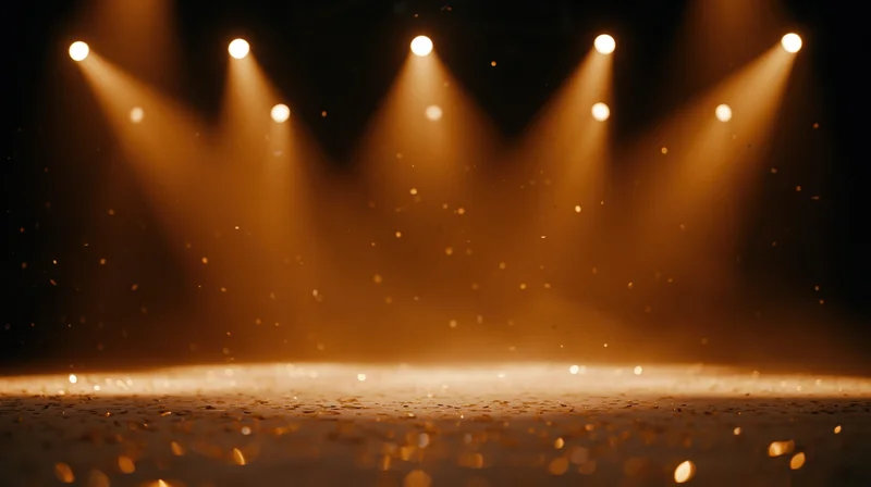 Stage floor illuminated by warm spotlights with floating dust particles and bokeh glow