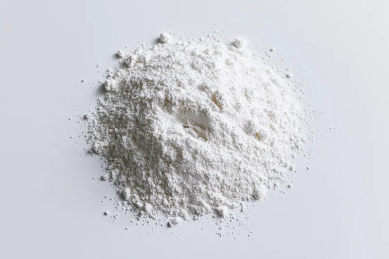 A pile of fine white powder on a flat white surface