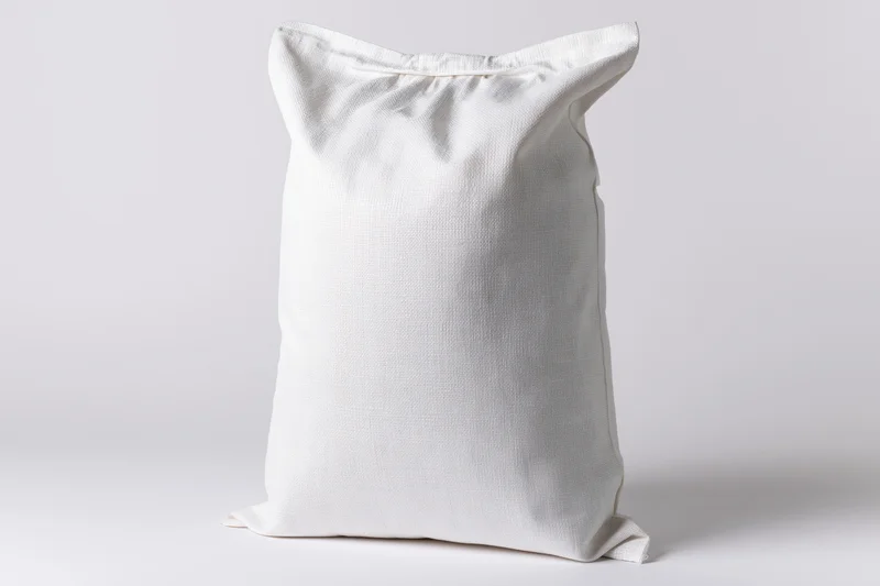 White woven polypropylene sack standing upright on plain background