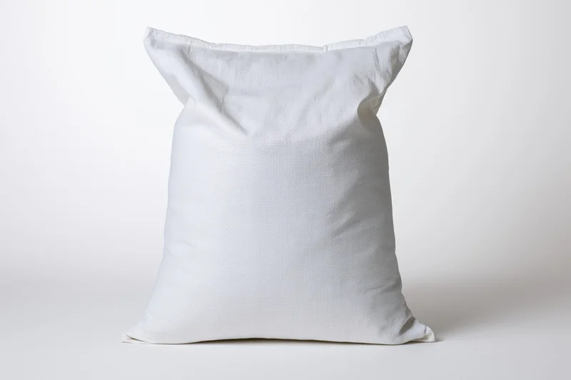 White woven polypropylene sack standing upright on plain background