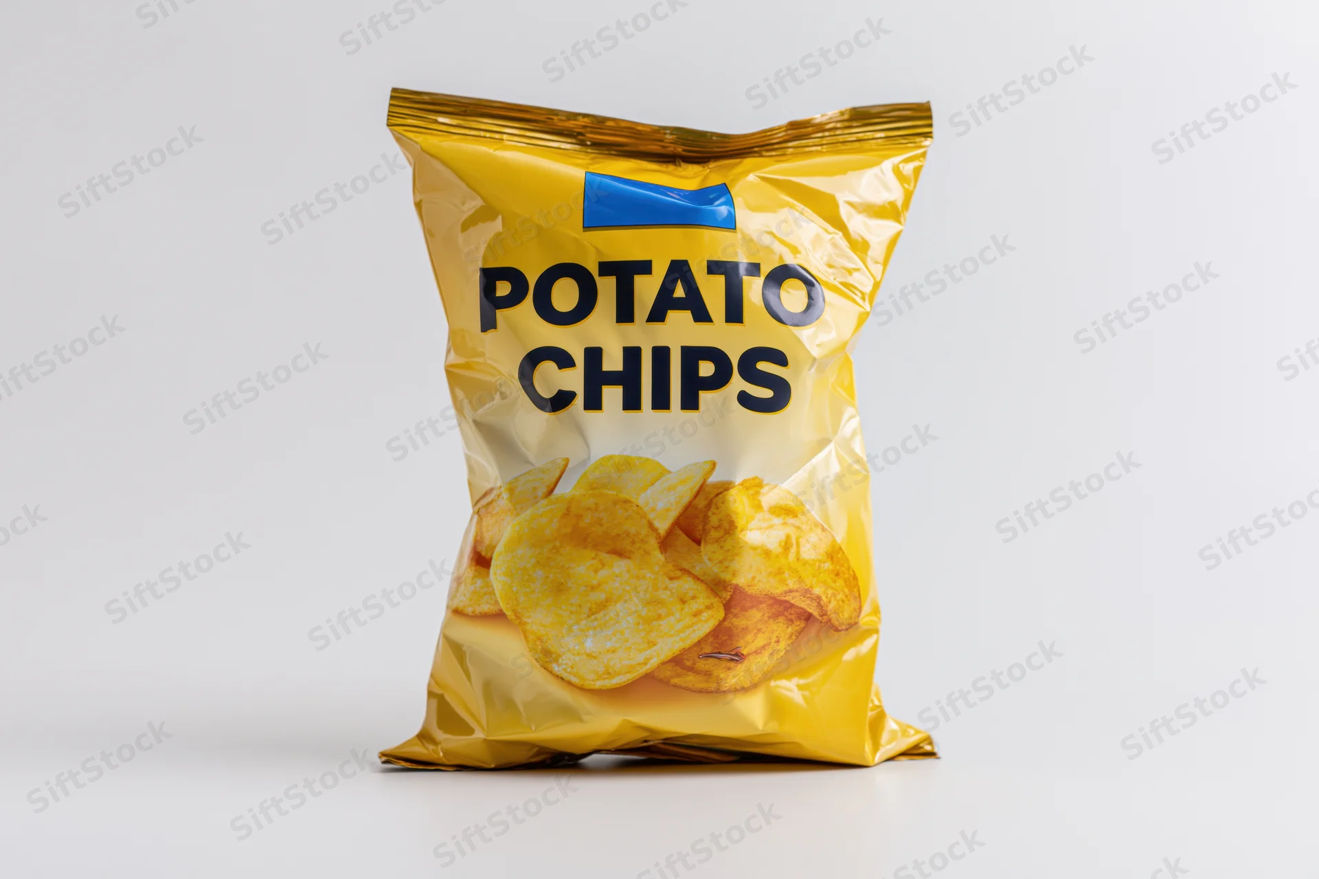 Sealed bag of potato chips standing upright on white surface