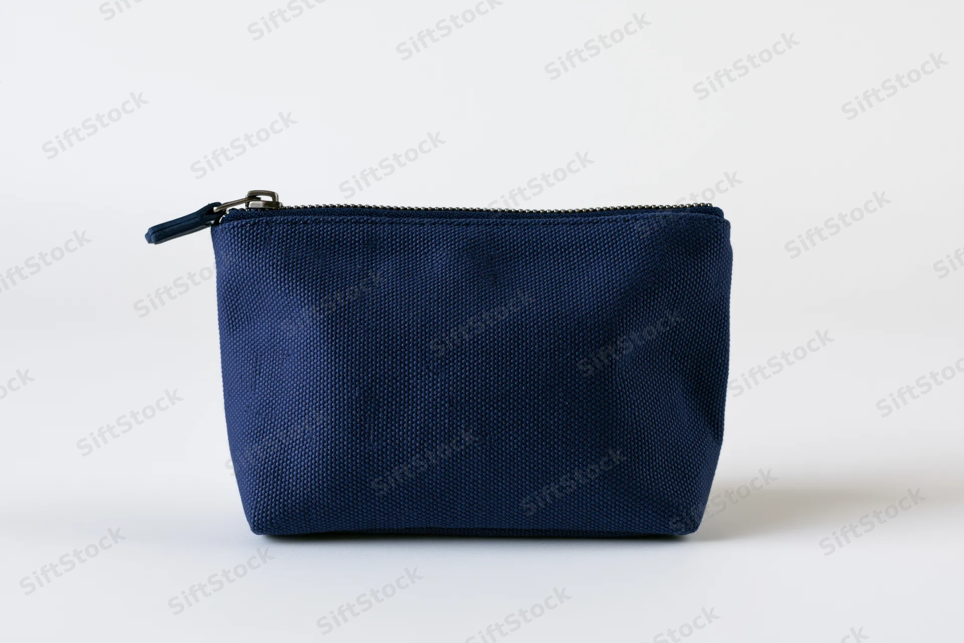 Navy blue canvas cosmetic pouch with top zipper on white background