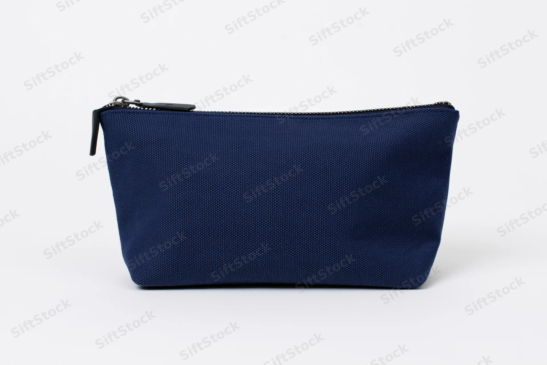Navy blue canvas cosmetic pouch with top zipper on white background