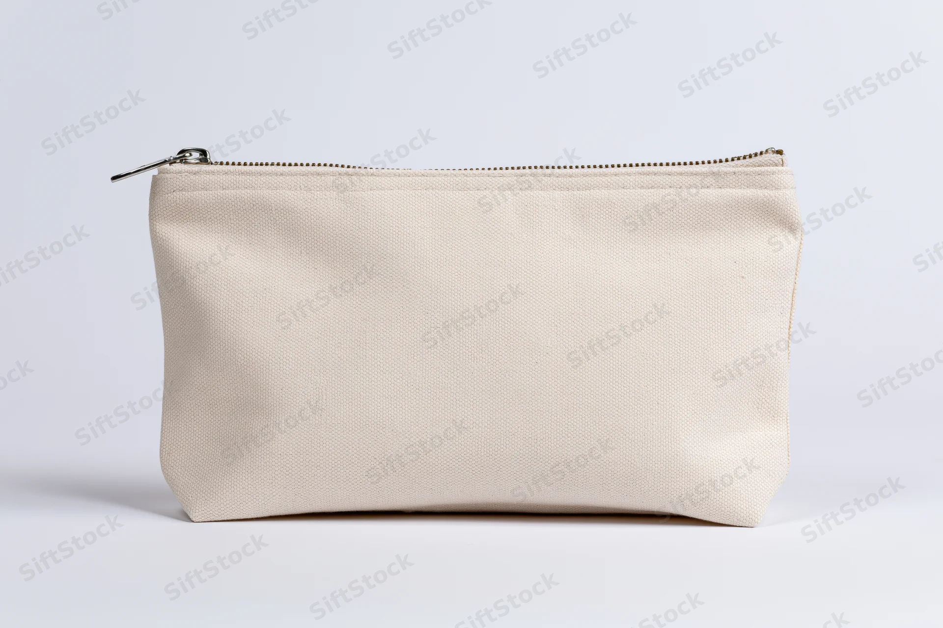Small beige canvas pouch with zipper standing upright on white background