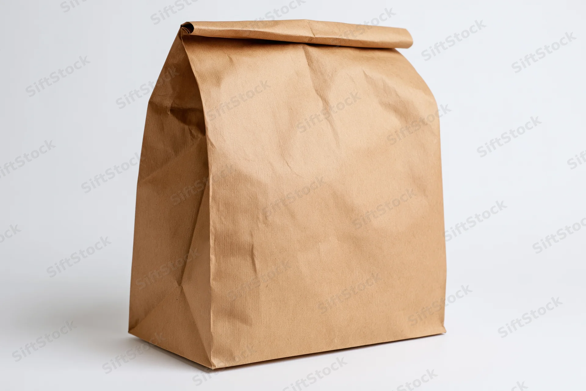 Brown kraft paper bag standing upright on white background