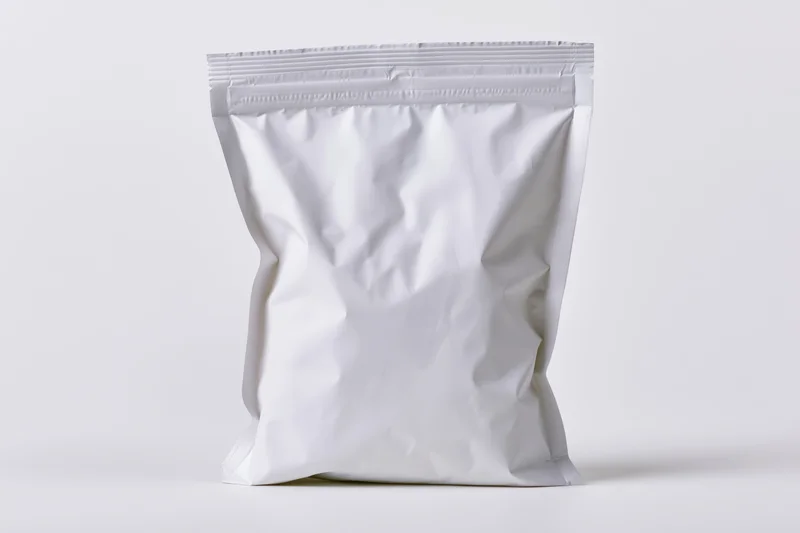 White foil snack pouch standing upright on plain background