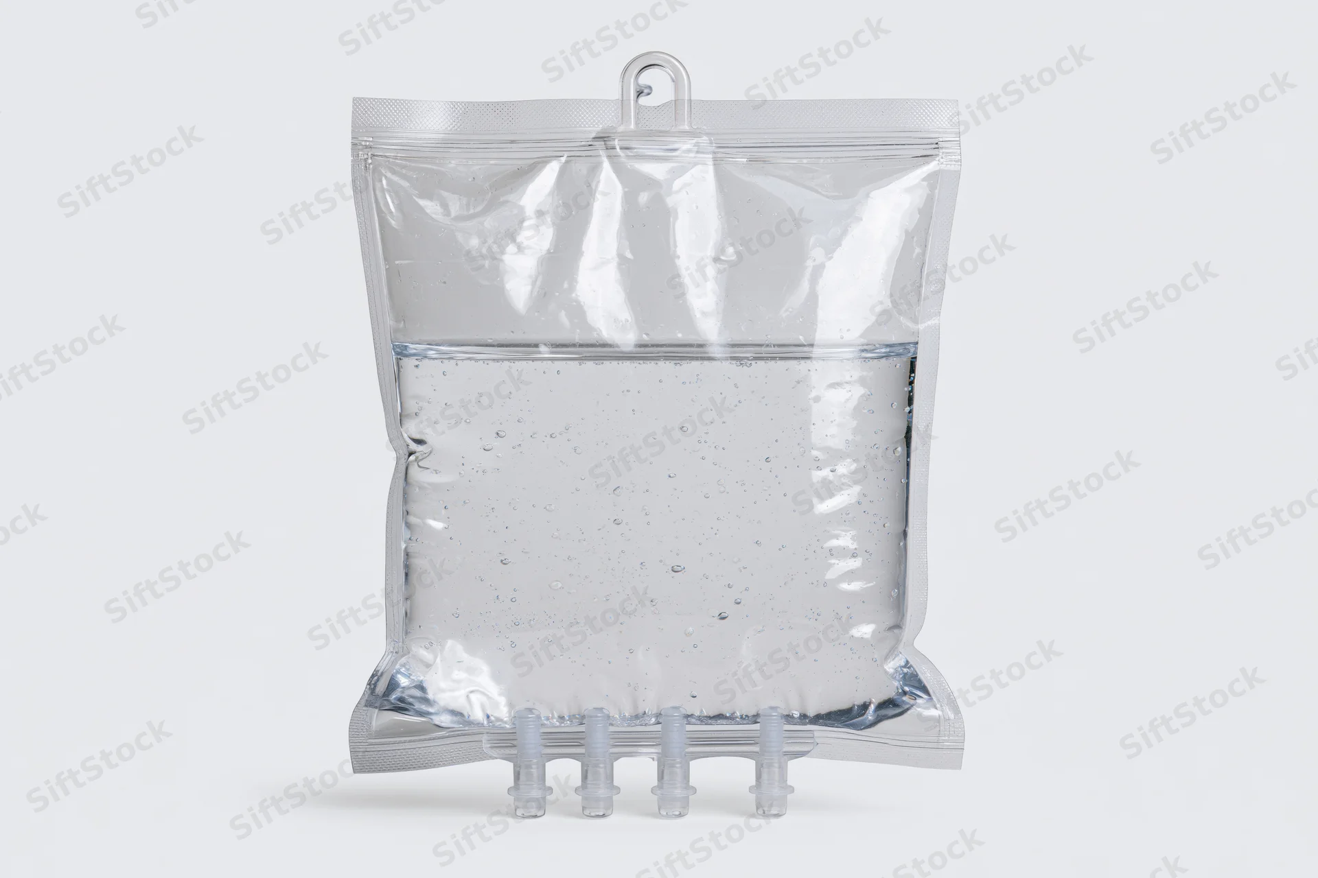 Clear medical iv saline bag filled with transparent fluid on white background