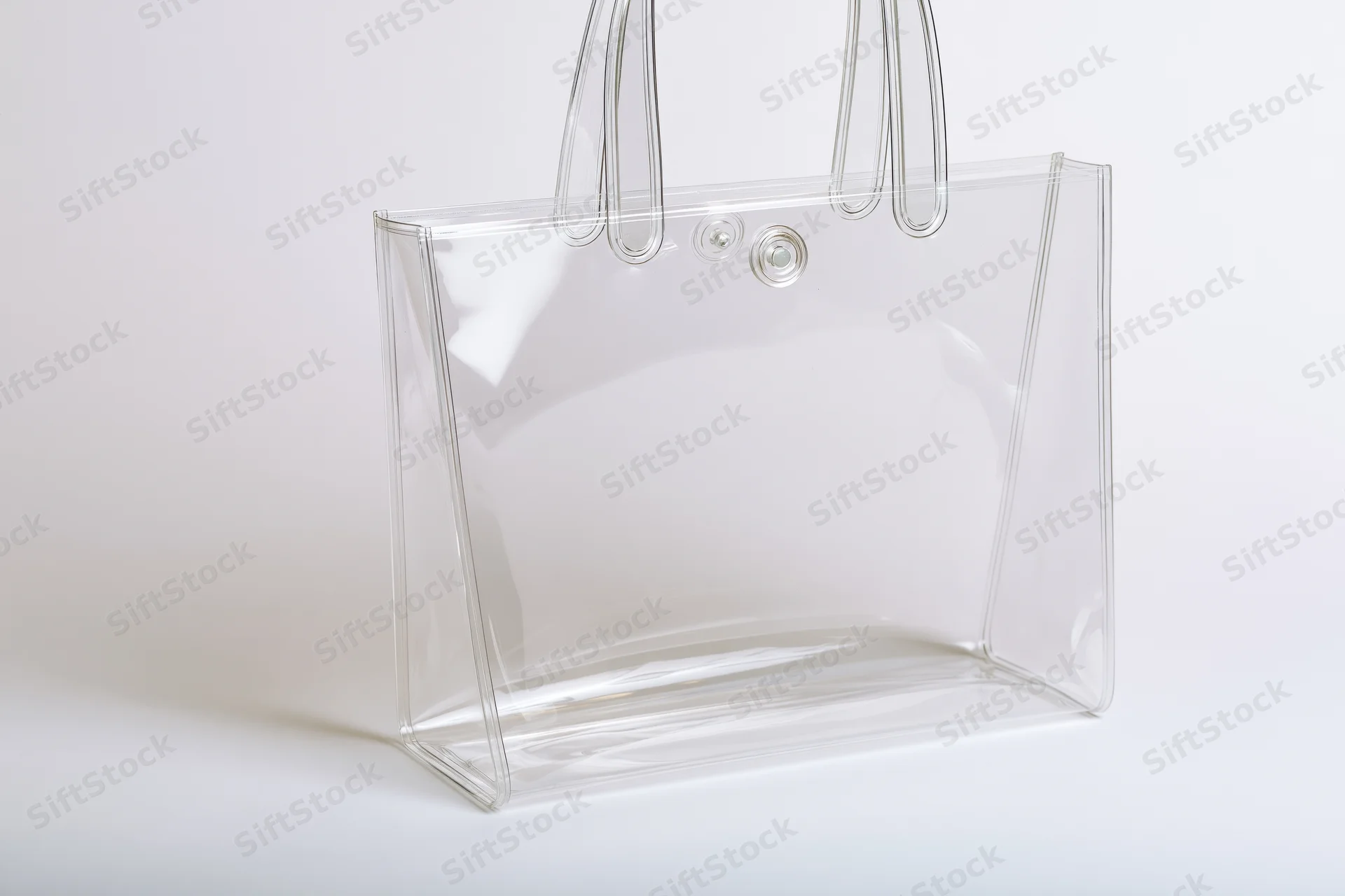 Transparent tote bag with rigid loop handles on white background