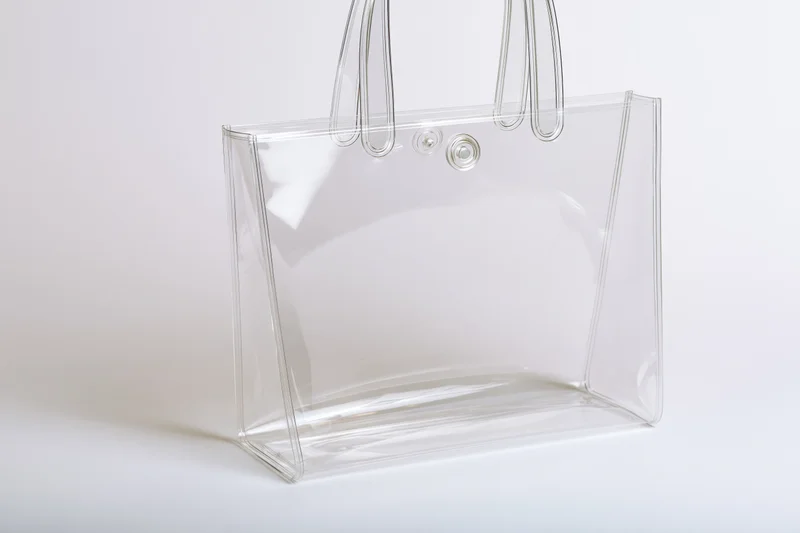 Transparent tote bag with rigid loop handles on white background