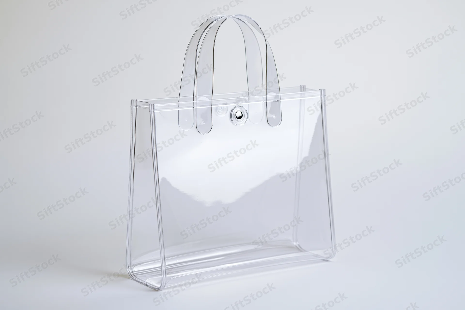 Clear transparent pvc tote bag with rigid loop handles on white background
