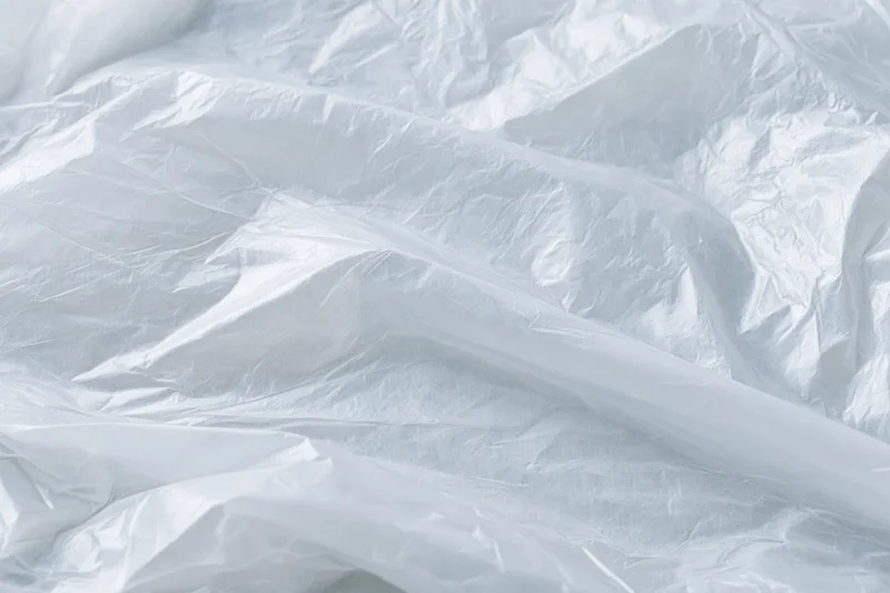 Crumpled clear plastic wrap sheet in close-up flat lay view