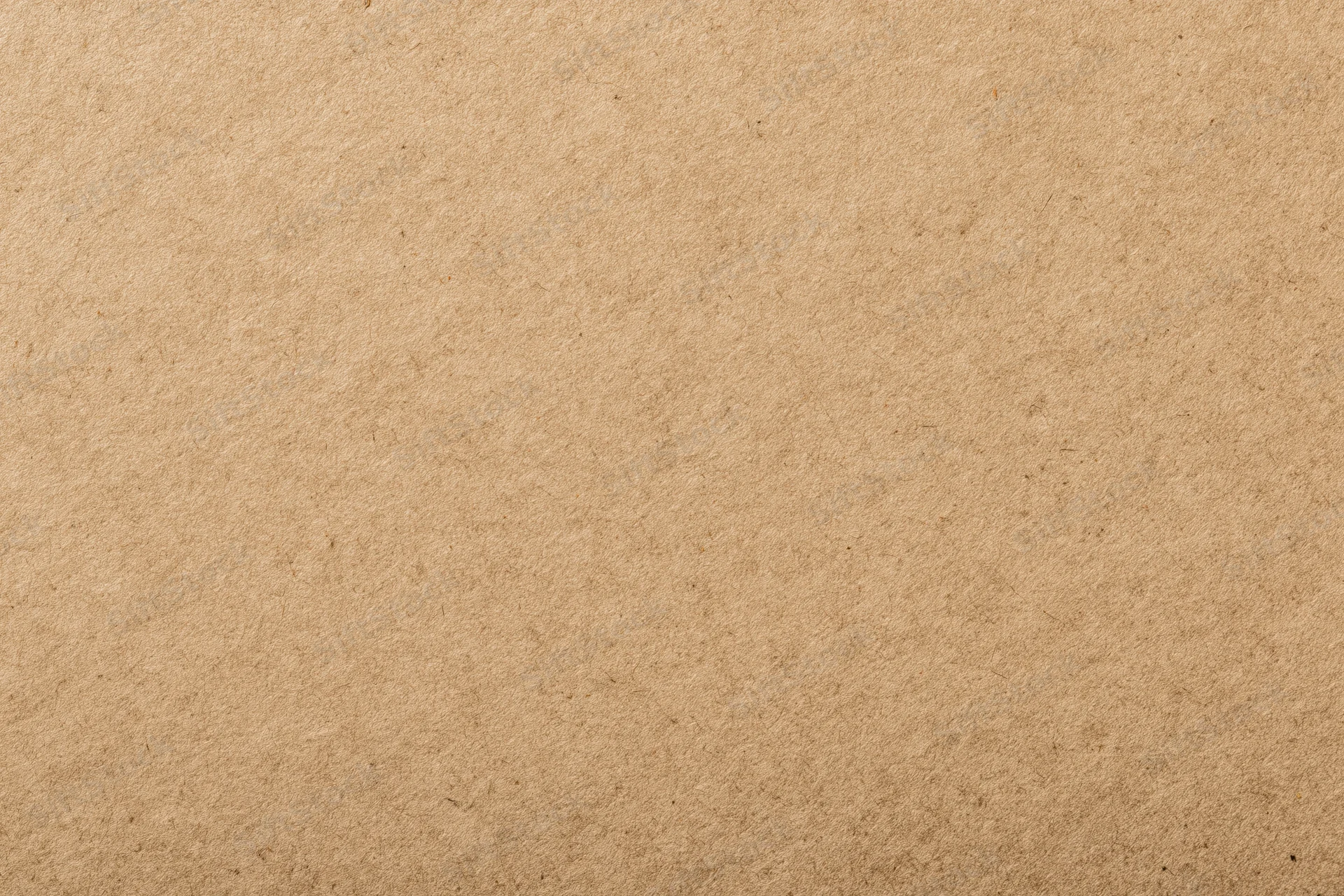 Close-up of a flat sheet of kraft brown recycled paper with visible texture and fibers