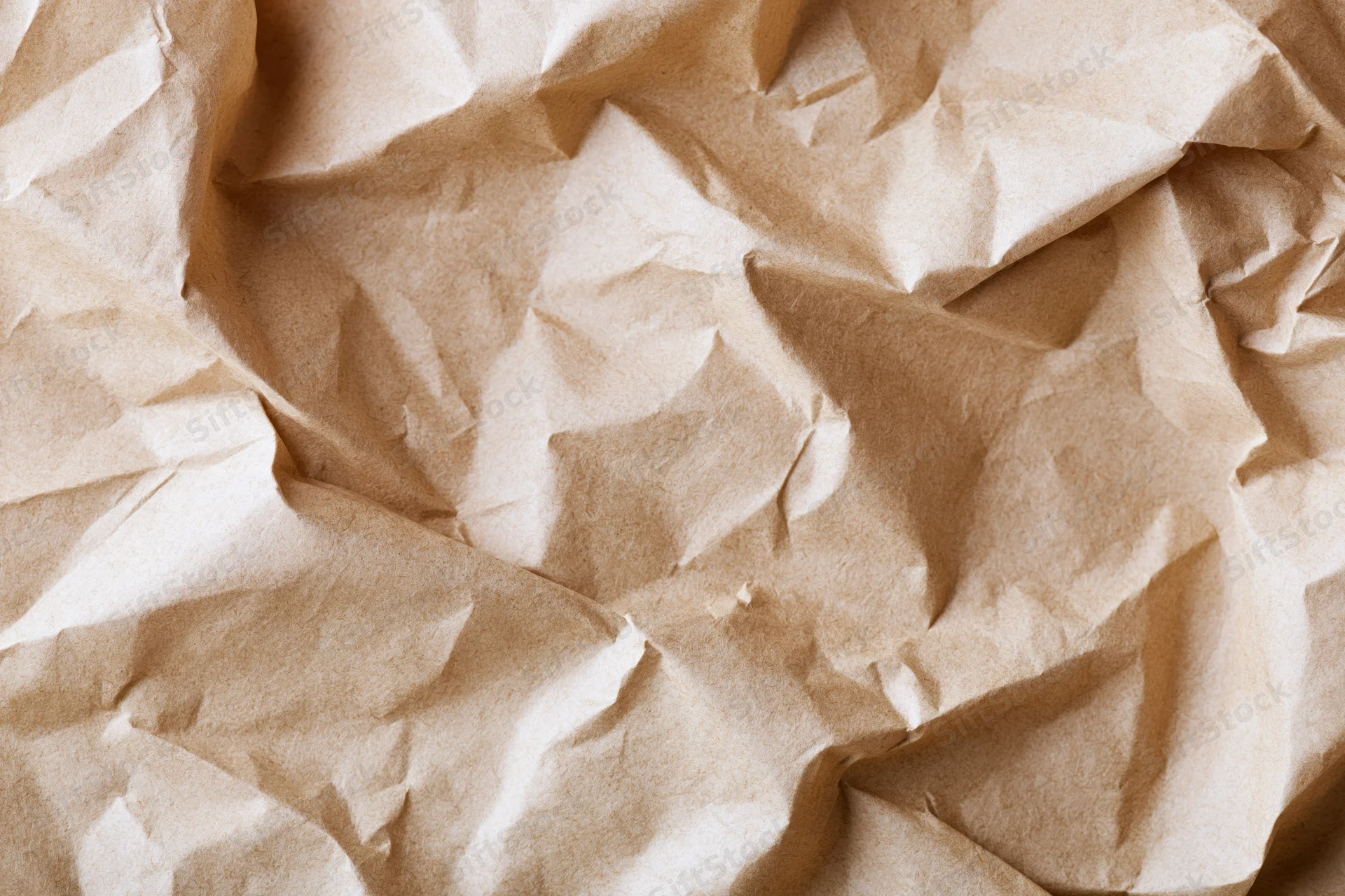 Crumpled brown kraft paper texture in flat lay view