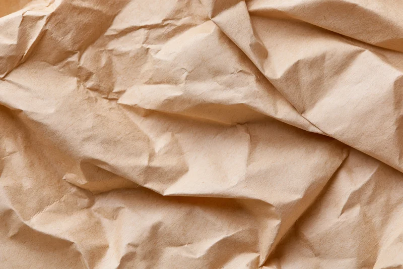 Crumpled brown kraft paper filling the frame as a textured surface
