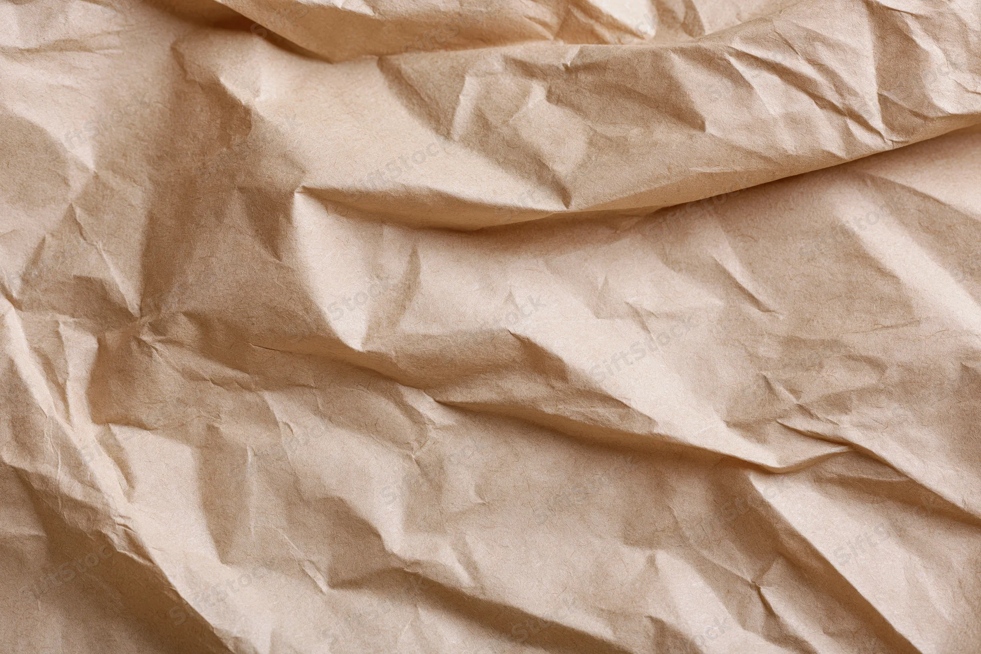 Crumpled brown kraft paper texture in flat lay arrangement