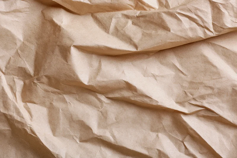 Crumpled brown kraft paper texture in flat lay arrangement