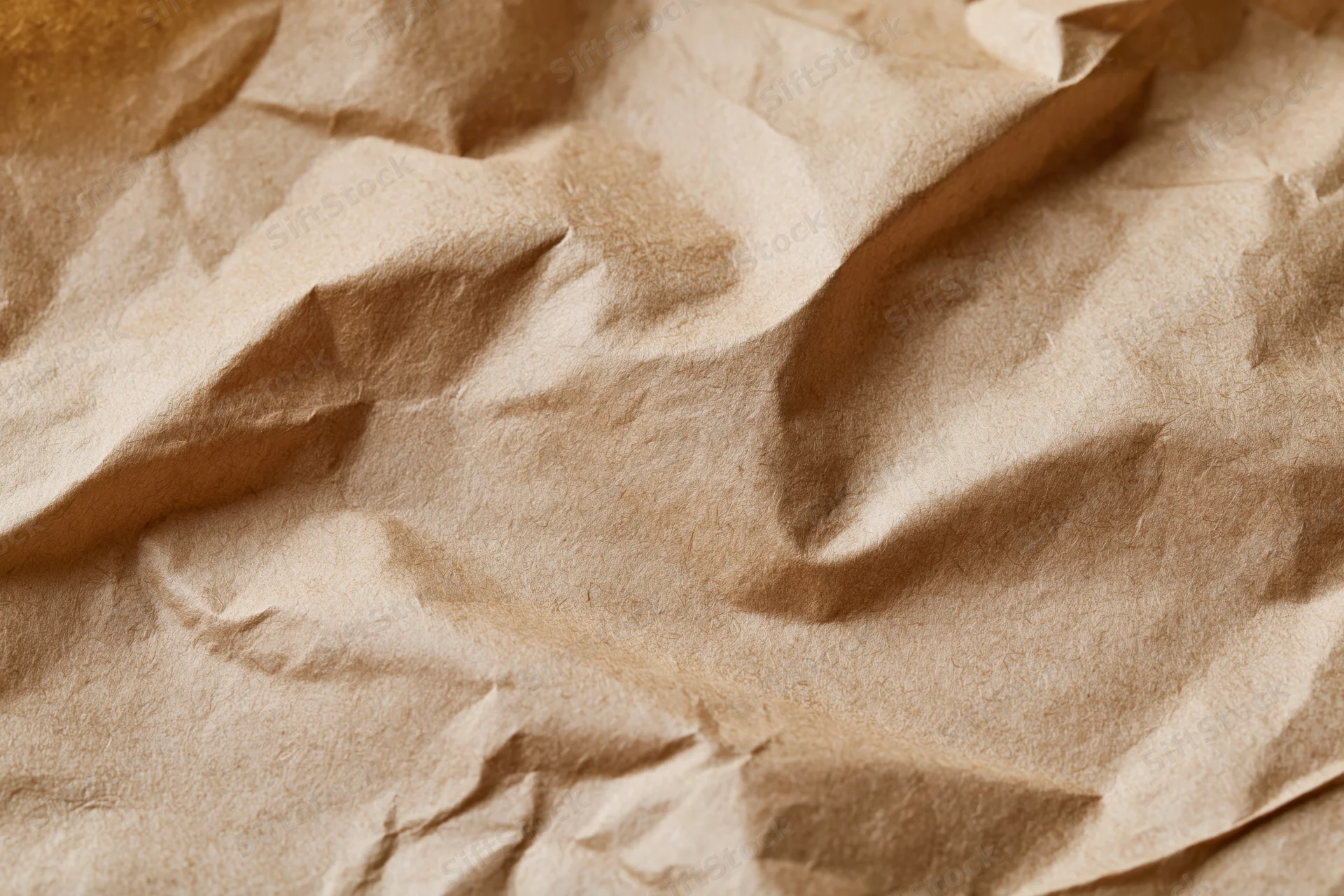 Crumpled brown kraft paper filling the frame as a textured surface