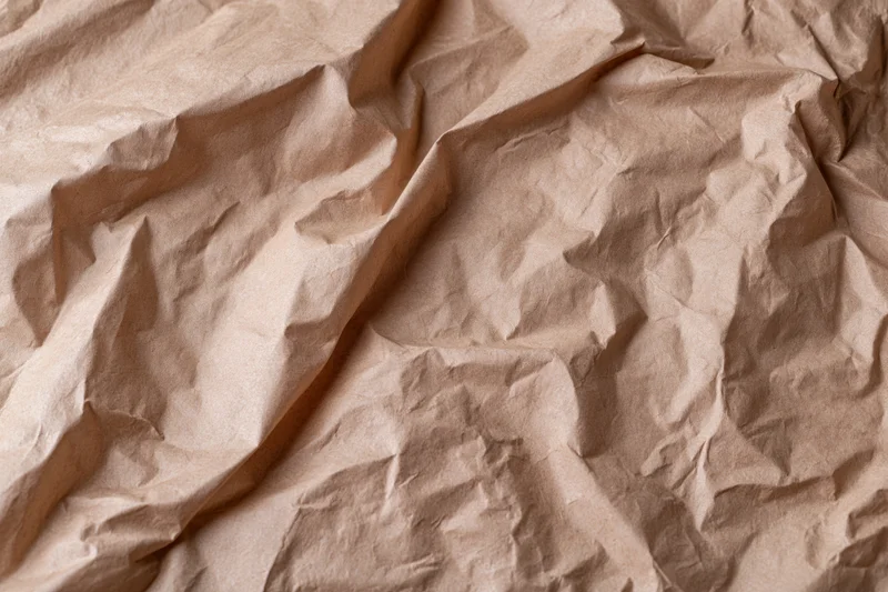 Crumpled brown kraft paper filling the frame as a textured background