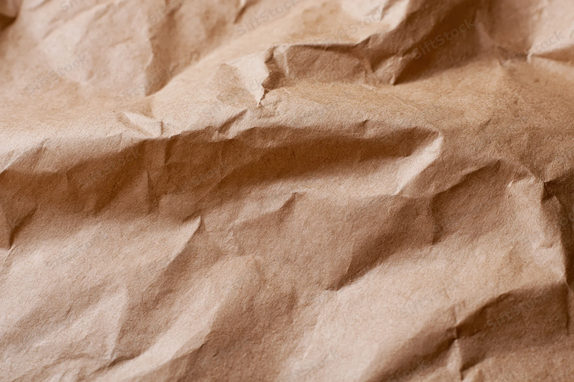 Crumpled brown kraft paper filling the frame as a textured surface